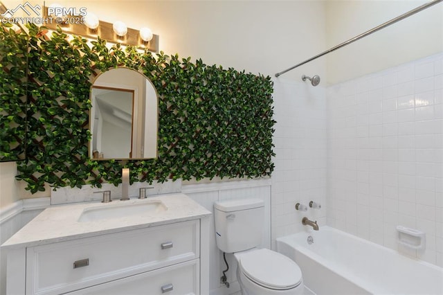 bathroom featuring shower / tub combination, toilet, a wainscoted wall, vanity, and wallpapered walls