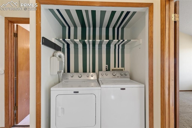 clothes washing area with laundry area, carpet flooring, and washer and dryer