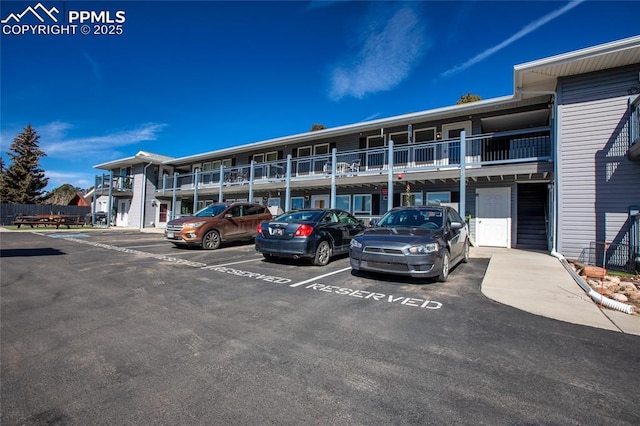 view of building exterior featuring uncovered parking