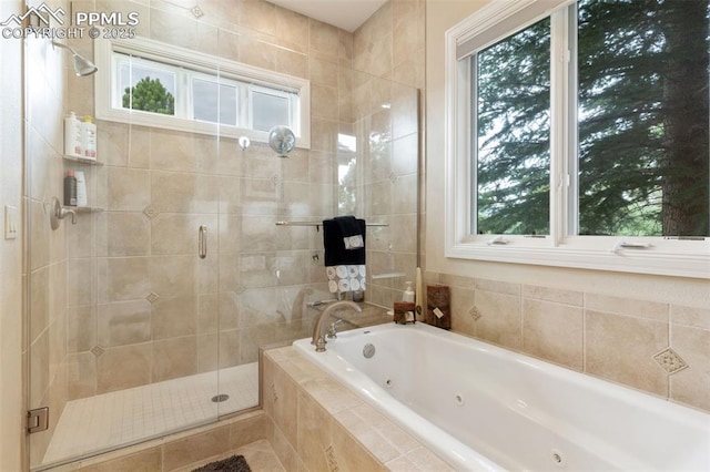 bathroom with a stall shower and a tub with jets