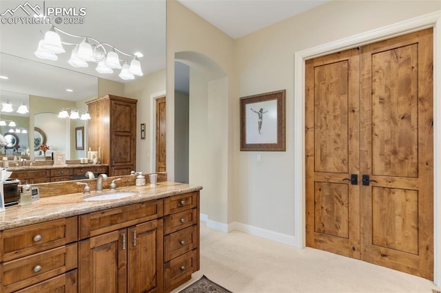 bathroom featuring baseboards and vanity