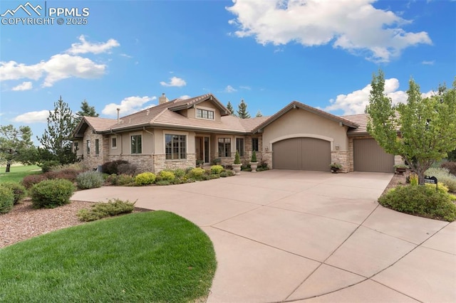 view of front facade with stone siding, concrete driveway, an attached garage, and stucco siding