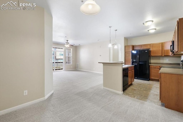 kitchen featuring light carpet, a kitchen island, open floor plan, hanging light fixtures, and black appliances