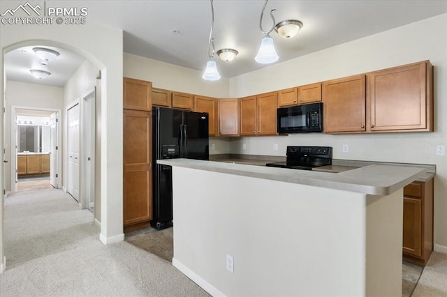 kitchen featuring arched walkways, brown cabinets, light carpet, a kitchen island, and black appliances