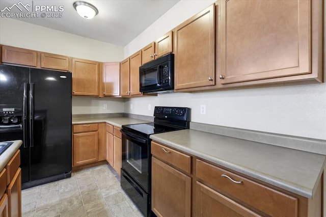 kitchen with brown cabinets, light countertops, and black appliances