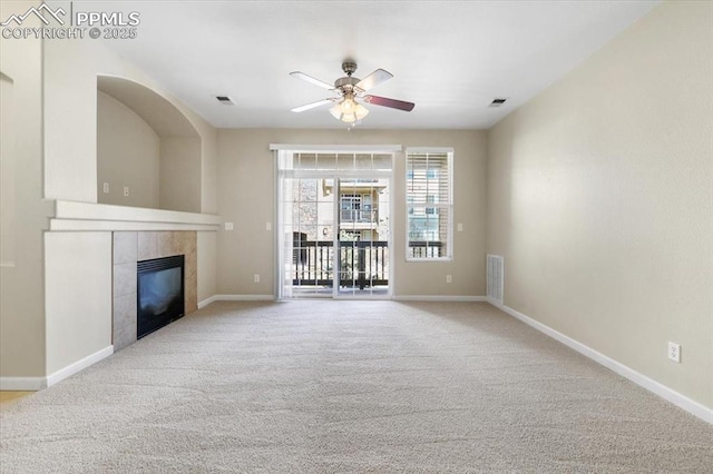 unfurnished living room featuring a fireplace, visible vents, light carpet, ceiling fan, and baseboards