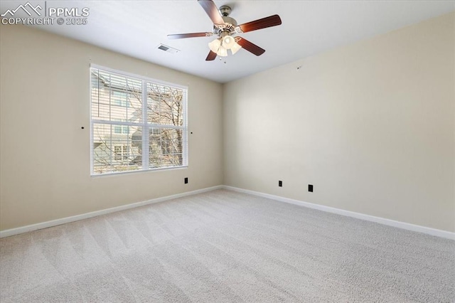 spare room with light colored carpet, ceiling fan, visible vents, and baseboards