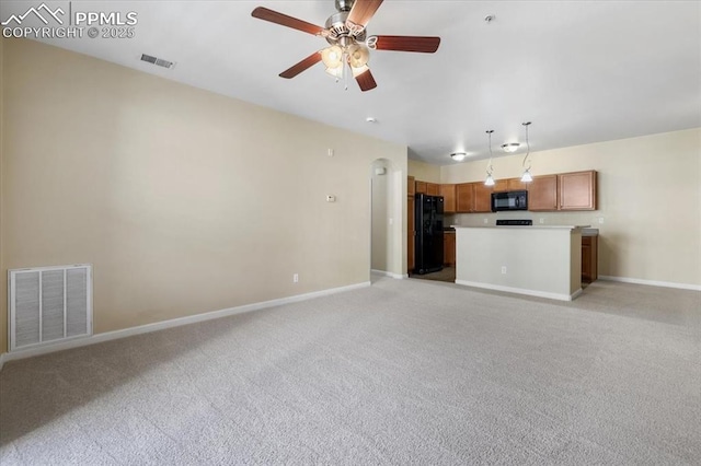 unfurnished living room with light carpet, visible vents, and baseboards