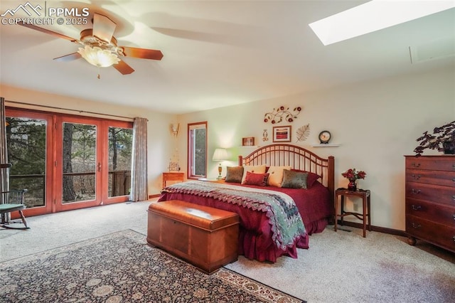 bedroom featuring access to exterior, carpet, a skylight, ceiling fan, and baseboards