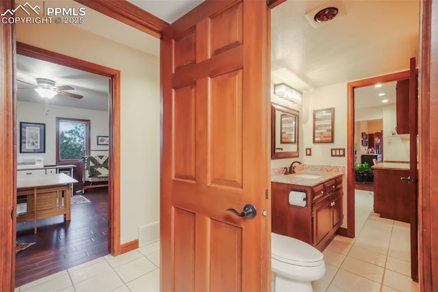 bathroom featuring visible vents, toilet, a ceiling fan, vanity, and tile patterned flooring