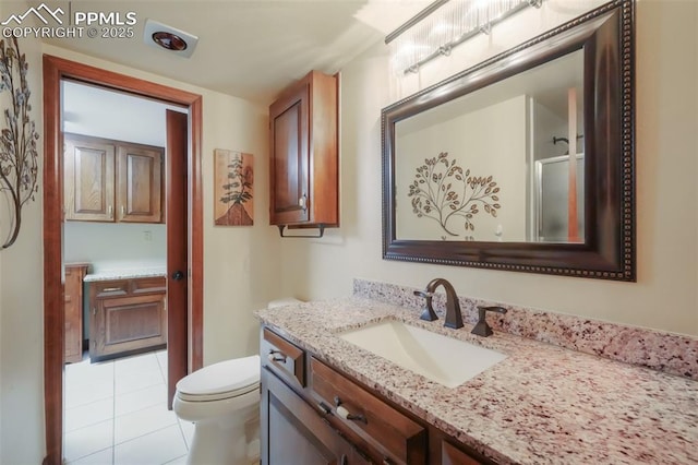 bathroom featuring vanity, toilet, and tile patterned floors