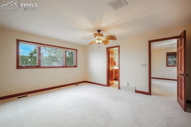 empty room with light colored carpet, visible vents, and baseboards