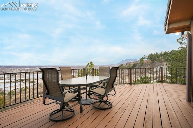 wooden terrace with outdoor dining space