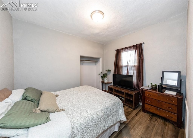 bedroom featuring dark wood-style flooring