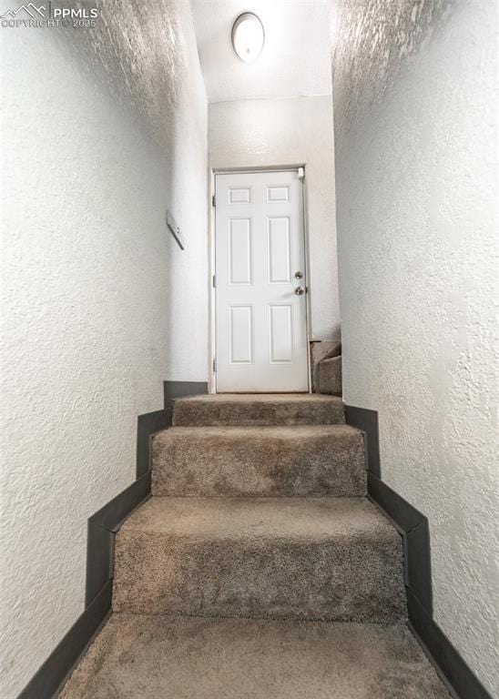 stairway with a textured wall