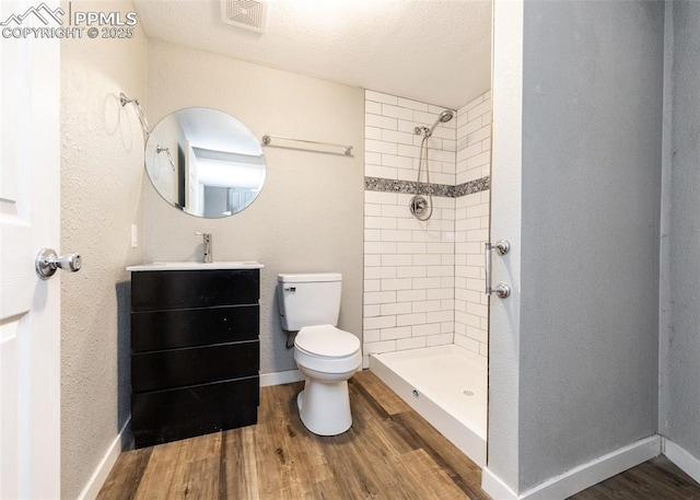 full bath featuring visible vents, toilet, a stall shower, vanity, and wood finished floors