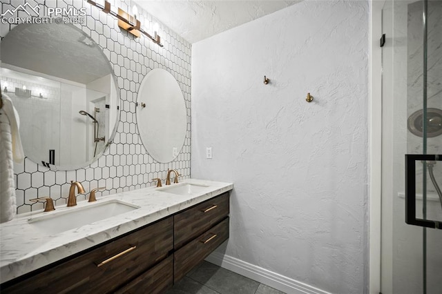 full bath featuring double vanity, a sink, decorative backsplash, and tile patterned floors