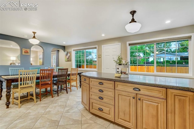 kitchen featuring arched walkways, light tile patterned floors, recessed lighting, and pendant lighting