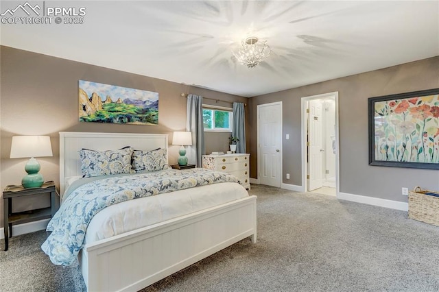 carpeted bedroom featuring baseboards and ensuite bathroom