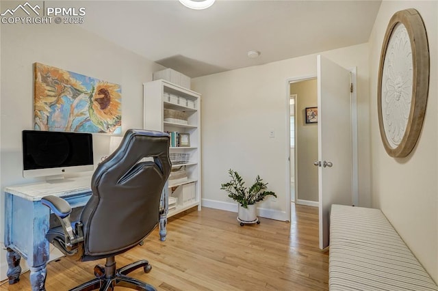 home office featuring light wood-type flooring and baseboards