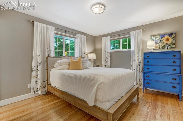 bedroom featuring wood finished floors and baseboards