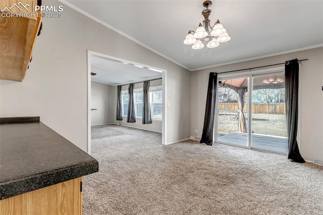 interior space featuring lofted ceiling, a wealth of natural light, crown molding, and carpet flooring