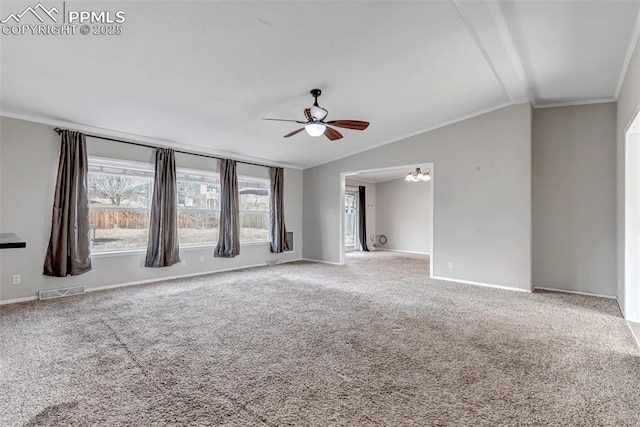 spare room with carpet, crown molding, lofted ceiling, visible vents, and baseboards