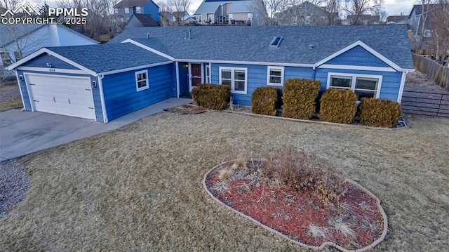 ranch-style home with driveway, roof with shingles, an attached garage, and fence