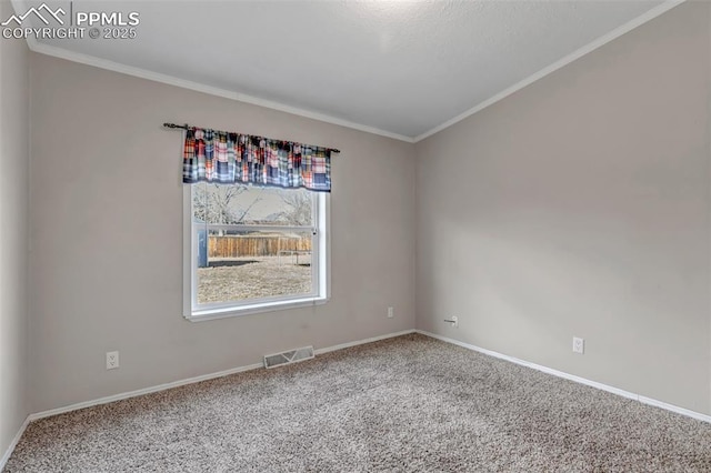 unfurnished room featuring baseboards, visible vents, carpet flooring, and ornamental molding