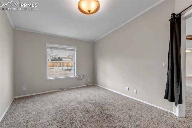 carpeted empty room featuring visible vents, crown molding, and baseboards