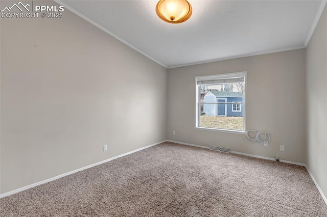 carpeted empty room featuring lofted ceiling, ornamental molding, visible vents, and baseboards