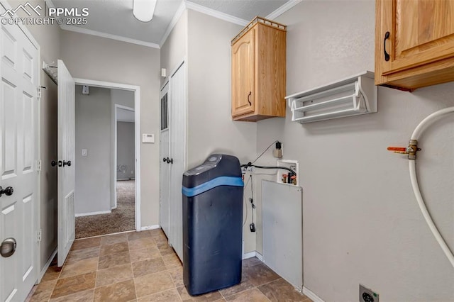 washroom with electric dryer hookup, ornamental molding, cabinet space, and baseboards