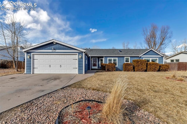 single story home with driveway, an attached garage, fence, and a front yard