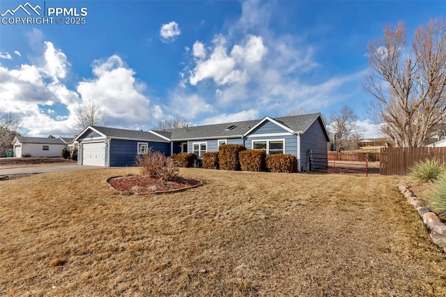 ranch-style home featuring driveway, an attached garage, fence, and a front yard