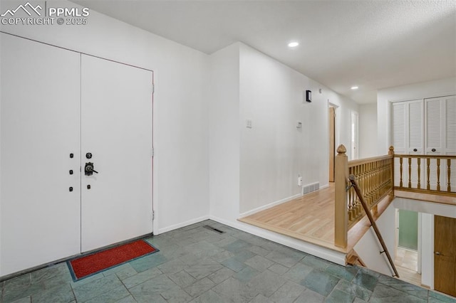 entryway with recessed lighting, visible vents, and baseboards