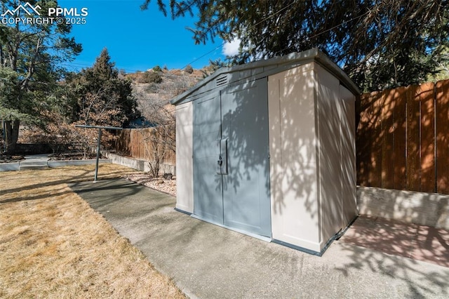 view of shed featuring a fenced backyard