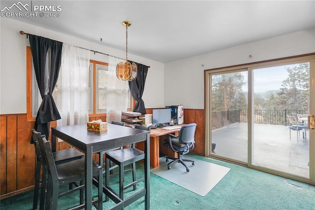 carpeted home office featuring wainscoting and wooden walls