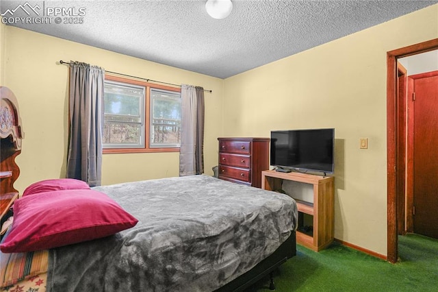 bedroom with carpet flooring, a textured ceiling, and baseboards