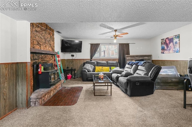 living area with carpet, wood walls, and wainscoting