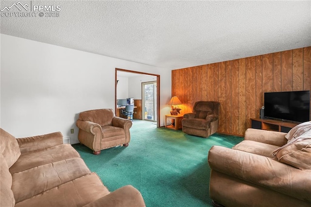 carpeted living room with wooden walls and a textured ceiling