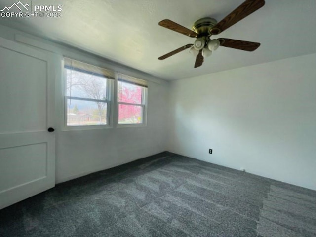 spare room featuring dark colored carpet