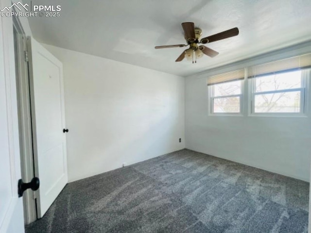 empty room with ceiling fan and carpet flooring