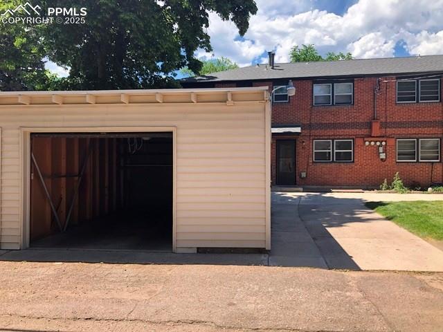 view of front facade featuring a garage, concrete driveway, and brick siding