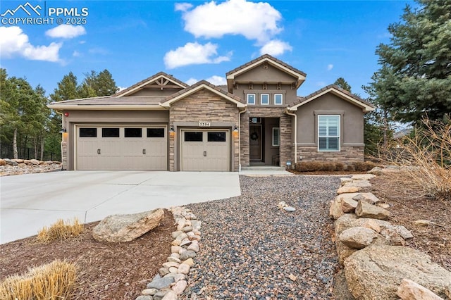 craftsman house with stucco siding, concrete driveway, a garage, stone siding, and a tiled roof