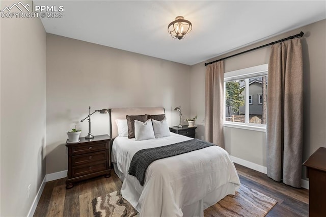 bedroom featuring wood finished floors and baseboards