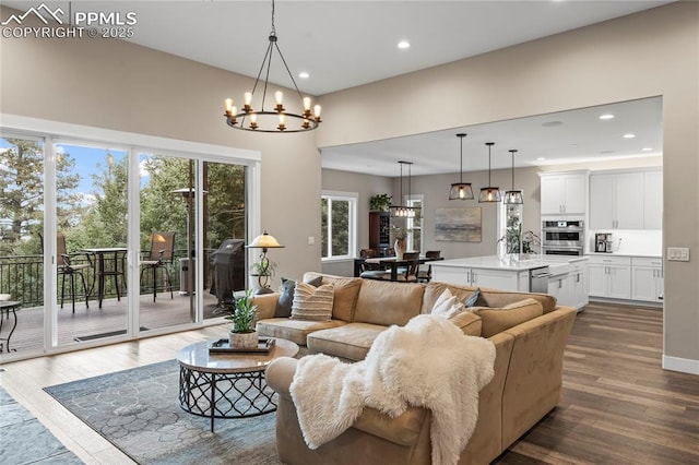 living room featuring a chandelier, recessed lighting, and dark wood finished floors