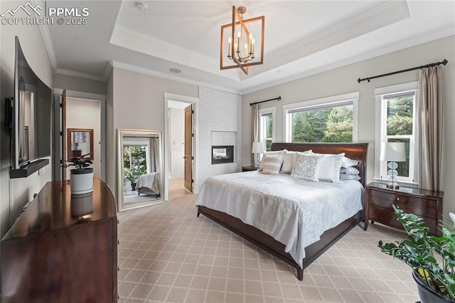 bedroom with light carpet, a raised ceiling, crown molding, a fireplace, and a notable chandelier