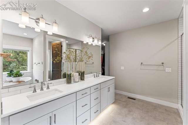 full bath featuring walk in shower, visible vents, a sink, and double vanity