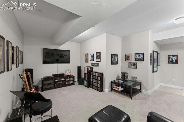 carpeted living area with baseboards