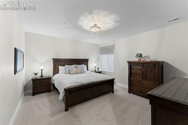 bedroom featuring light colored carpet, visible vents, and baseboards